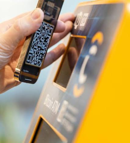 Scanning a wallet QR code on a phone at a CoinFlip bitcoin ATM